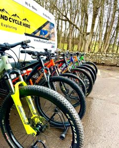Pentland Cycle Hire mountain bikes lined up against van 